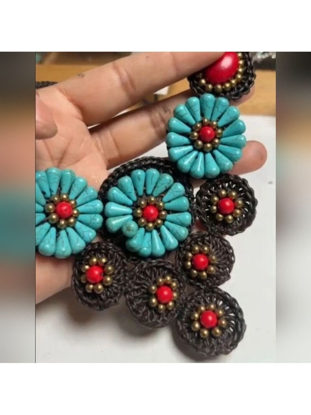 Artisanal statement necklace features simulated turquoise and red coral stones